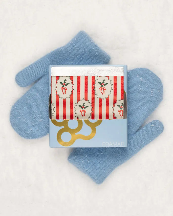 A blue mitten next to one of the 2026 calendar's gift boxes