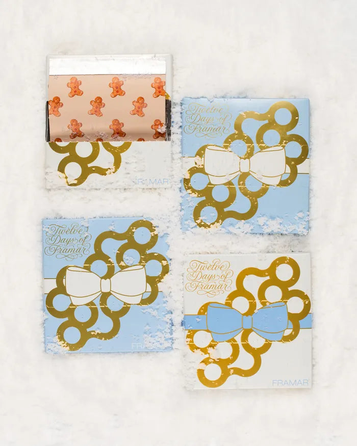 2026 calendar gift boxes decorated with blue ribbons and gold bows