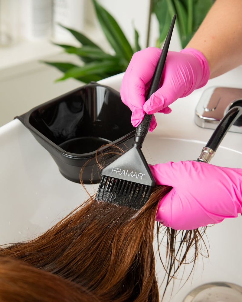 Stylist toning hair with Toning Tub nearby